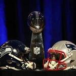 The Vince Lombardi Trophy was flanked by Seahawks and Patriots helmets prior to a news conference Friday with coaches Pete Carroll and Bill Belichick.